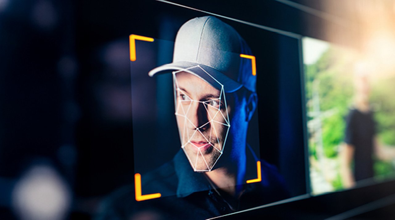 Face of a man wearing a baseball cap being analyzed by facial recognition software