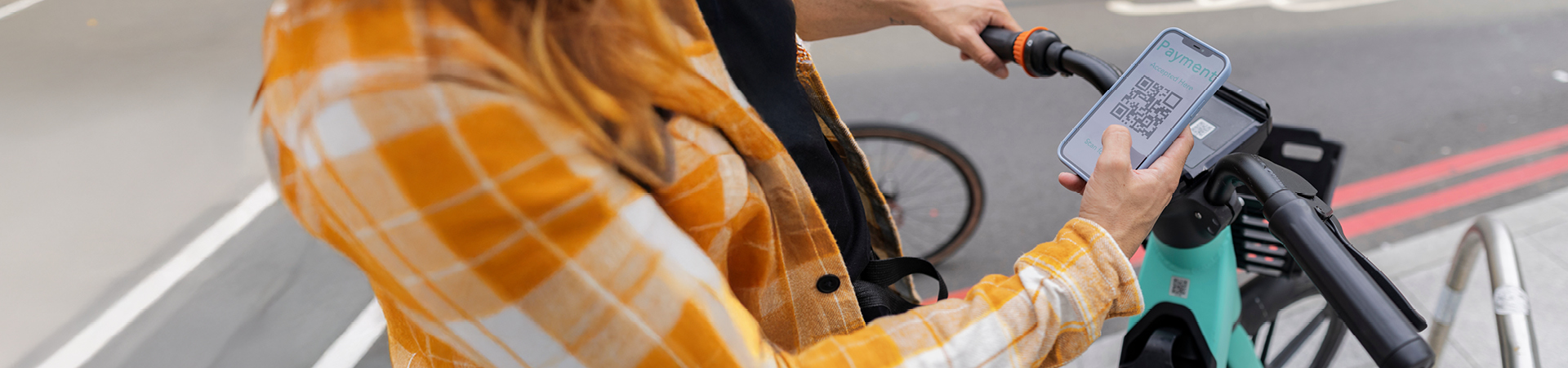 Woman scans a QR code on an e-scooter